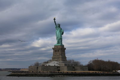 Statue of liberty against cloudy sky