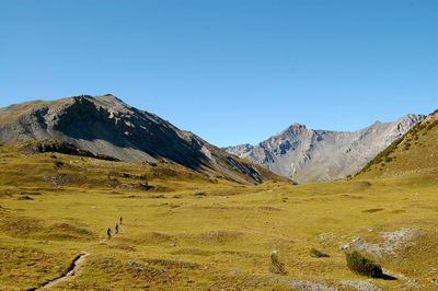 Scenic view of mountains against clear blue sky