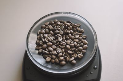 Close-up of roasted coffee beans on weight scale