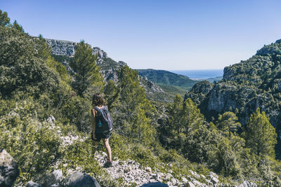 Man standing on rock against mountains