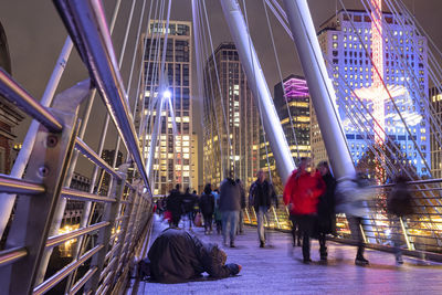 People at illuminated city at night