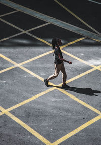 High angle view of man walking on road