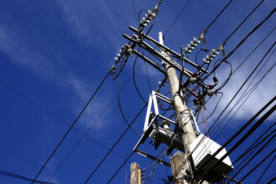 Low angle view of electricity pylon against sky