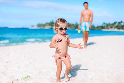 Full length of shirtless boy on beach