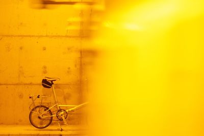 Side view of bicycle parked against the wall