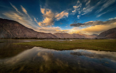 Scenic view of lake against sky during sunset