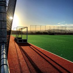 Scenic view of soccer field against sky during sunset