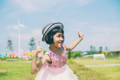 Full length of smiling girl on field