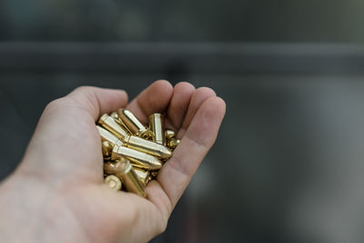 Close-up of hand holding bullets