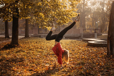 Hello fall, autumn season, fall mood, positive emotions. teenager girl jumping with transparent