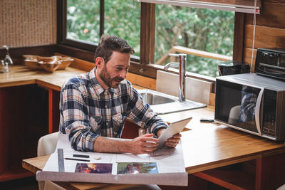 Man working on table at home