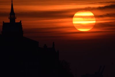 Silhouette temple against sky during sunset