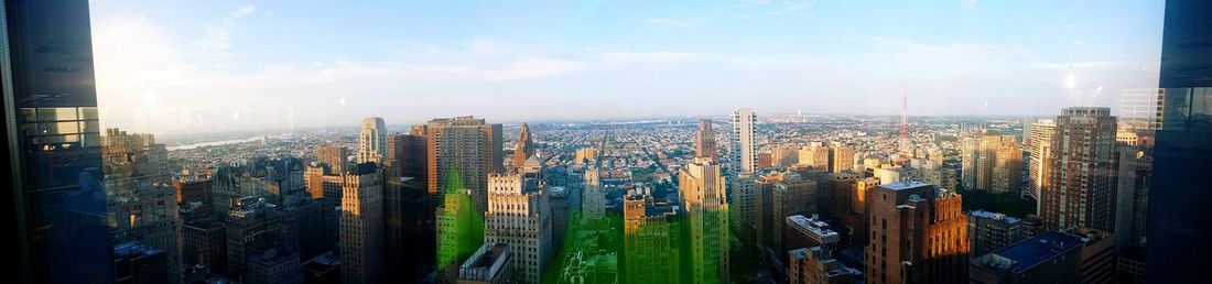 Panoramic view of city buildings against sky