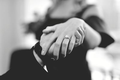 Midsection of couple holding hands