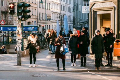 Group of people walking on city street