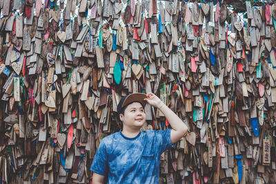 Portrait of teenage boy standing against wall