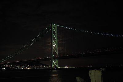 Low angle view of suspension bridge at night