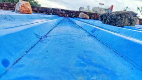 Surface level of road against blue sky