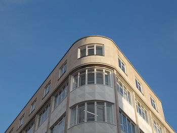 Low angle view of building against clear blue sky