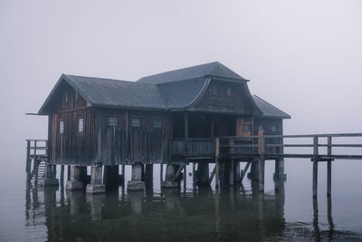 House by sea against clear sky