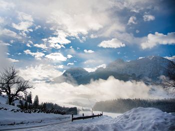 Scenic view of snow covered mountains against sky