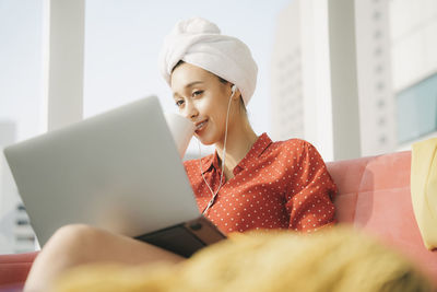 Teenage girl looking away while using smart phone