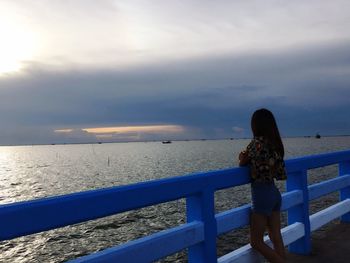 Rear view of girl standing on beach