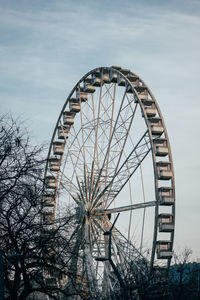 Low angle view of ferris wheel against sky