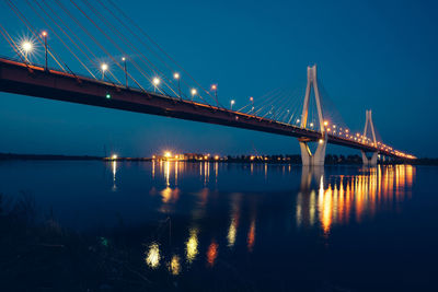 Night glowing bridge over the river