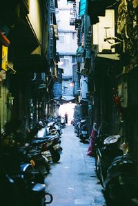 Narrow alley amidst buildings in city at night