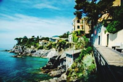 Panoramic view of sea and buildings against sky