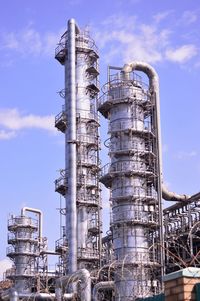 Low angle view of smoke stack against sky