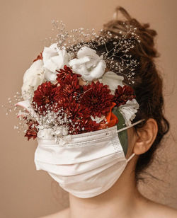 Close-up of woman holding white flowers