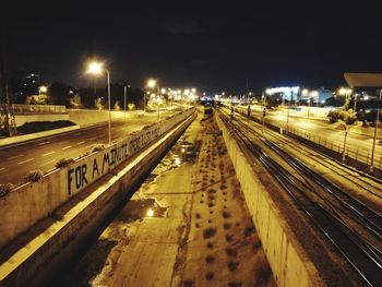 High angle view of railway tracks at night