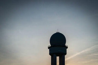 Low angle view of tower and building against sky