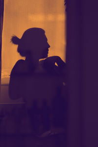 Silhouette woman in bathtub