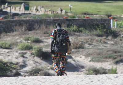 Rear view of man and woman walking on land