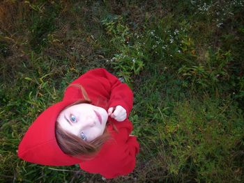 Close-up portrait of girl lying on grass