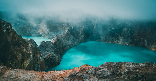 Scenery of kelimutu lake under foggy weather