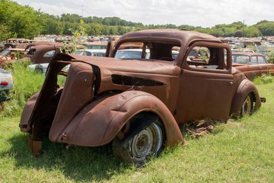 Abandoned car on field