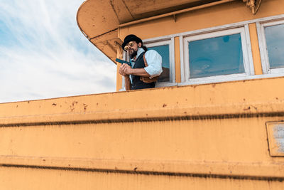 Low angle view of man looking at camera