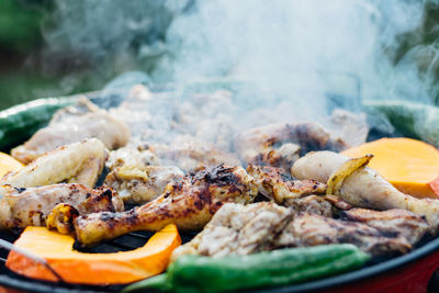 Close-up of meat and vegetables on barbecue grill