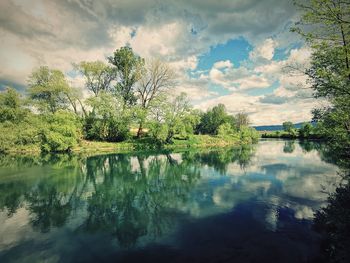 Reflection of trees in lake against sky