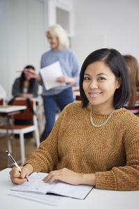 Portrait of smiling woman in class