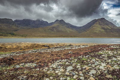 Scenic view of lake against cloudy sky