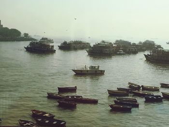 Boats in sea against sky