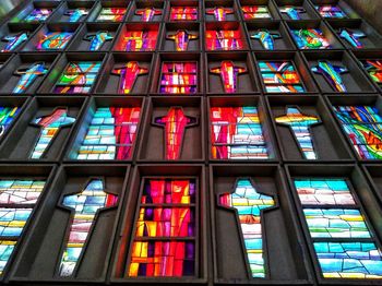 Low angle view of illuminated glass window in building