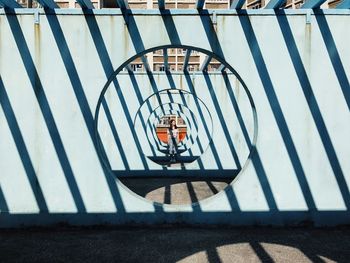 CLOSE-UP OF SHADOW HANGING ON METAL STRUCTURE