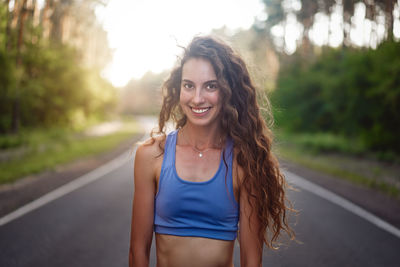 Portrait of smiling woman standing outdoors