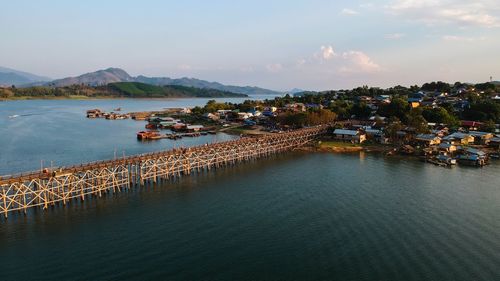 High angle view of sea by city against sky